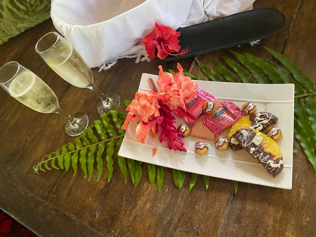 Champagne flutes and a chocolate-and-fruit plate